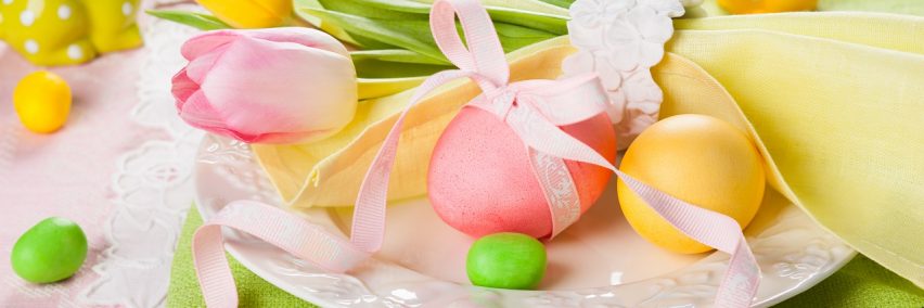 Easter table setting with tulips and easter eggs